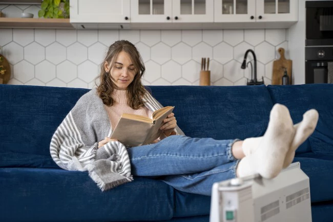 Full Shot Woman Reading Near Heater 1