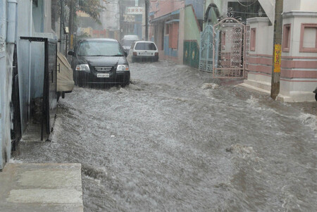 Calle inundada con coches aparcados