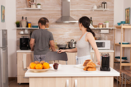 Cheerful Wife Talking With Her Husband Kitchen While Toasts Bread Breakfast Young Couple Morning Preparing Meal Together With Affection Love