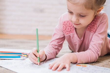 Close Up Of Girl Drawing In Book With Colored Pencil