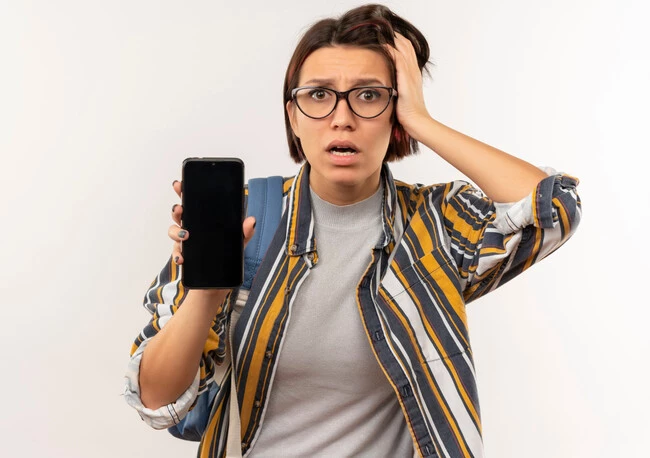 Anxious Young Student Girl Wearing Glasses Back Bag Showing Mobile Phone Putting Hand Head Isolated White