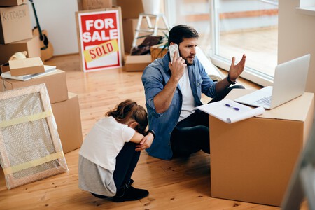 Displeased Father Using Laptop Talking Phone After Relocating Into New Home