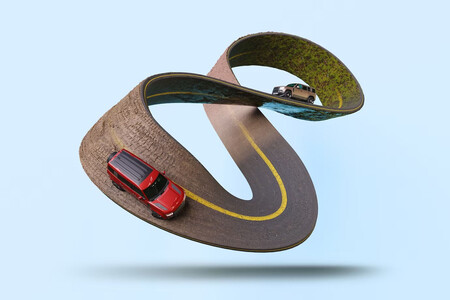 Representación surrealista de una carretera que hace un bucle infinito por el que circulan coches
