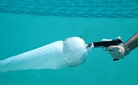 Disparando una pistola bajo el agua en slow motion