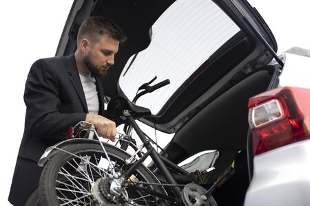 Young Man Using Folding Bike City