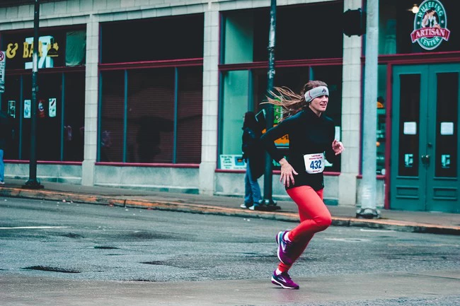 Woman Wearing Red Pants And Black Long Sleeved Top Running 1564466