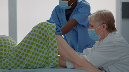 Childbirth Doctor Helping Caucasian Woman Deliver Baby Hospital Ward Bed African American Nurse Assisting Obstetrics Specialist Maternity Clinic Multi Ethnic Medical Team