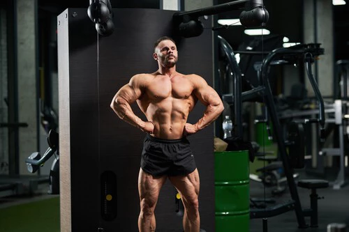 Handsome Bodybuilder Performing Front Lat Spread Pose 1