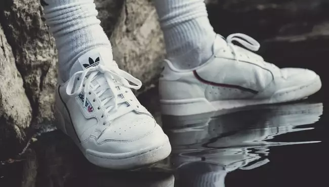 Person Wearing White Adidas Shoes 1225136