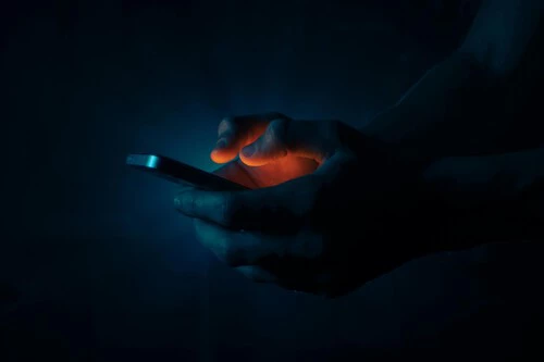 Free Photo Of Man Holding A Mobile Phone In The Dark