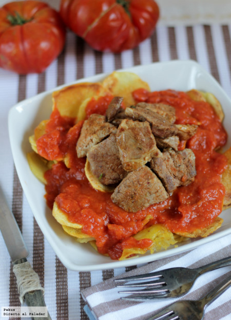 Presa ibérica adobada con patatas al pelotón. Receta