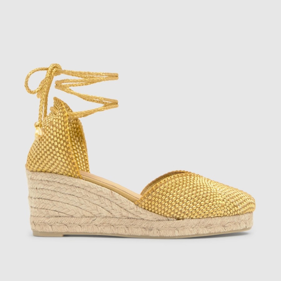 Castañer
Alpargata de mujer Cora de cuña con cierre de cordones e hilos metalizados.