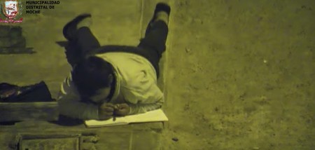 Un niño de 12 años hace sus deberes a la luz de una farola porque en su casa no hay luz: un ejemplo de superación