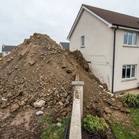 La obra del vecino amenaza con enterrar sus casa. La solución es perder 40 metros de parcela