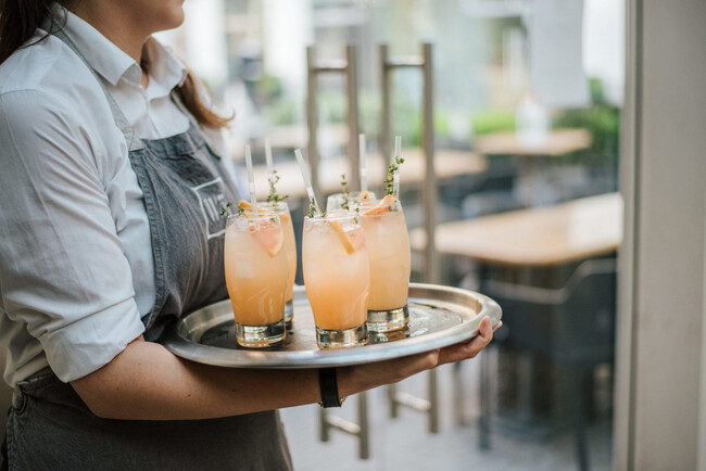 Closeup Shot Waiter Serving Cocktail With Fresh Oranges Silver Tray
