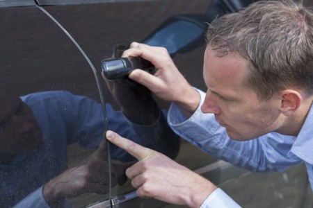 Examining A Car Park Scratch