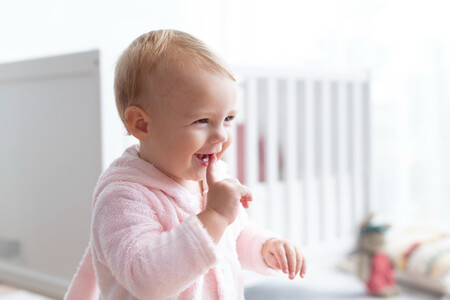 Cute Baby Girl Smiling In Her Nursery