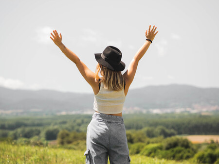 Blonde Woman Wearing Hat With Her Hands Up