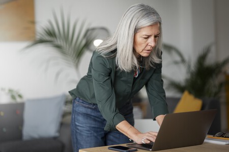 Medium Shot Old Woman Working Laptop Indoors