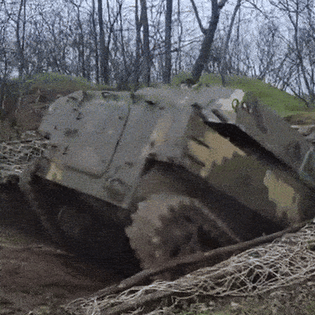A Ukrainian tank emerging from the ground
