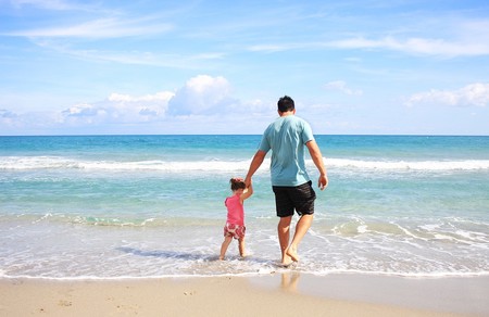 padre e hija en la orilla del mar