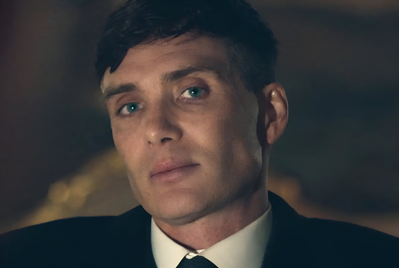 A woman in a dark top looking over her shoulder