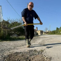 Las carreteras están tan mal en Italia que un cura ha cogido la pala y se ha puesto a arreglarlas él mismo 