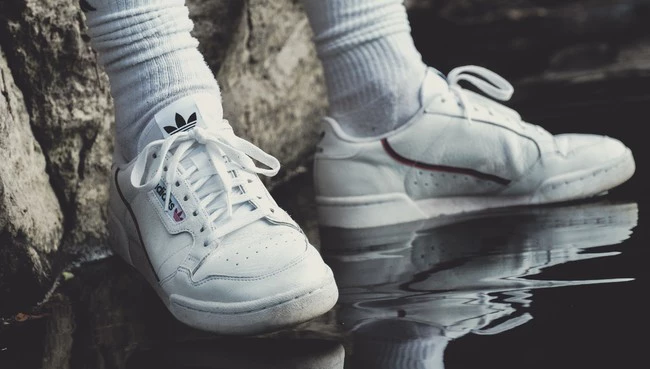 Person Wearing White Adidas Shoes 1225136