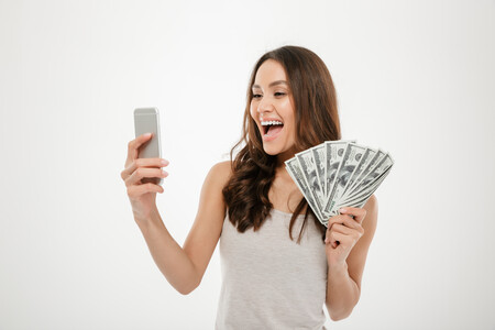 Portrait Happy Joyous Female 30s Demonstrating Lots Money Dollar Currency While Using Her Mobile Phone Isolated White