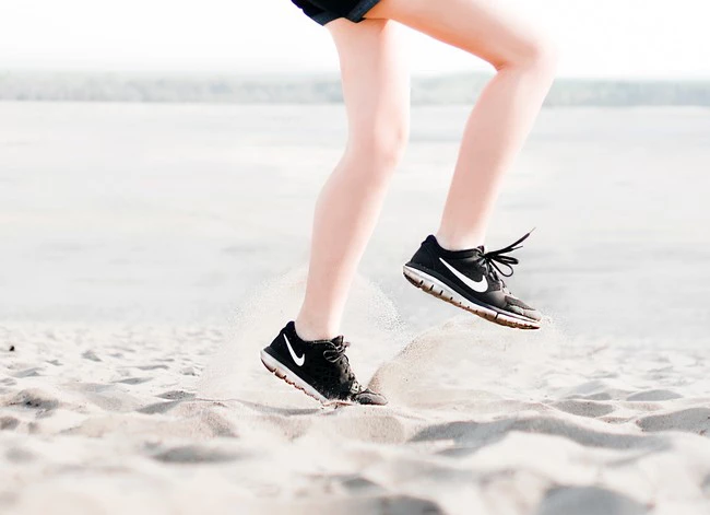Photo Of Woman Wearing Pair Of Black Nike Running Shoes 1166868