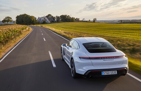 Porsche Taycan Turbo S blanco en una carretera secundario cerca de un pueblo.