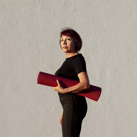Side View Woman Holding Fitness Mat