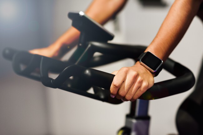 Woman At Gym Doing Spinning Or Cyclo Indoor With Smart Watch Min