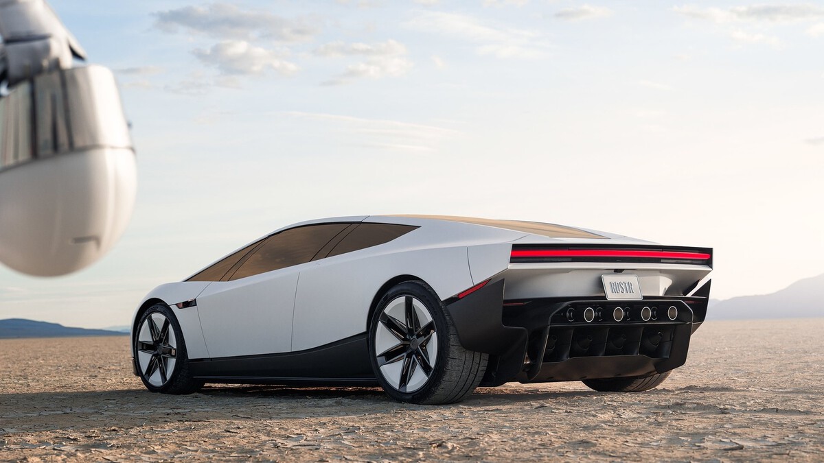 Rear three-quarter view of the white Tesla Roadster concept on a desert flat