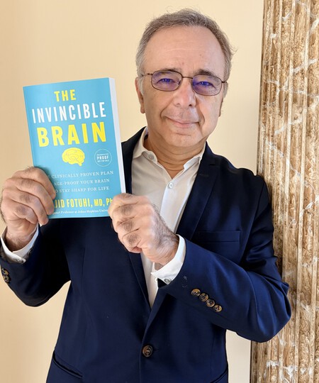 Dr Fotuhi Holding Book Copy Scaled