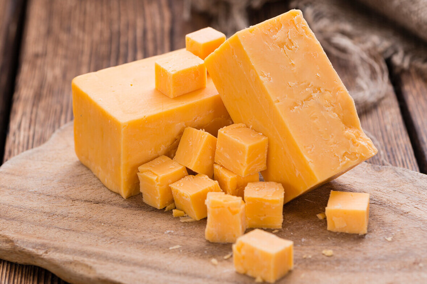 Where The Orange Color Of Cheddar Cheese Comes From (and How It Affects