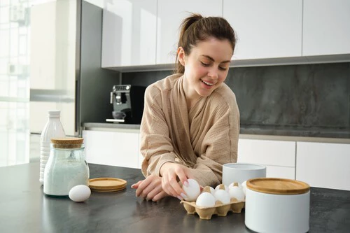 Attractive Young Cheerful Girl Baking Kitchen Making Dough Holding Recipe Book Having Ideas 1