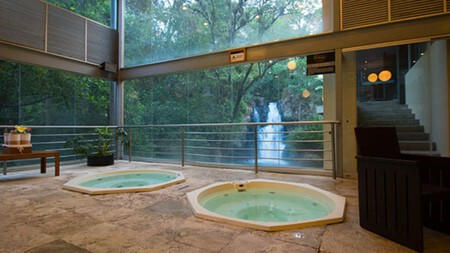 Ubicado en el Pueblo Mágico de Valle de Bravo, el Hotel Misión Grand Valle de Bravo ha causado furor debido a que aloja un asombroso jardín y una cascada en su interior como parte de sus atractivos.  Este destino te invita a pasar un momento especial en contacto con la naturaleza y, al mismo tiempo, de darte un respiro, pues aquí puedes reservar su jacuzzi privado, o bien, la alberca climatizada, espacios perfectos para ese momento cuando requieres una pausa de las actividades diarias.  Si buscas darte una escapada de la rutina, este hotel cuenta con diferentes opciones de hospedaje, así que, puedes ir con tu pareja, amigos o familia para pasar un rato ameno y disfrutar a lo grande.  El Hotel Misión Grand Valle de Bravo se encuentra entre monumentales árboles, por lo que la vista desde cualquier punto es privilegiada, porque, además, su cascada y río, son un deleite si estás en su restaurante.  Del Pueblito es el spot donde vas a poder deleitarte con distintas opciones de la gastronomía mexicana, tragos y cocteles clásicos y cuentan hasta con varias opciones de mezcal en su barra especializada. 