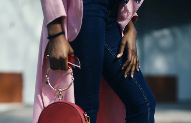 Woman Holding Round Leather 2 Way Handbag 1068638